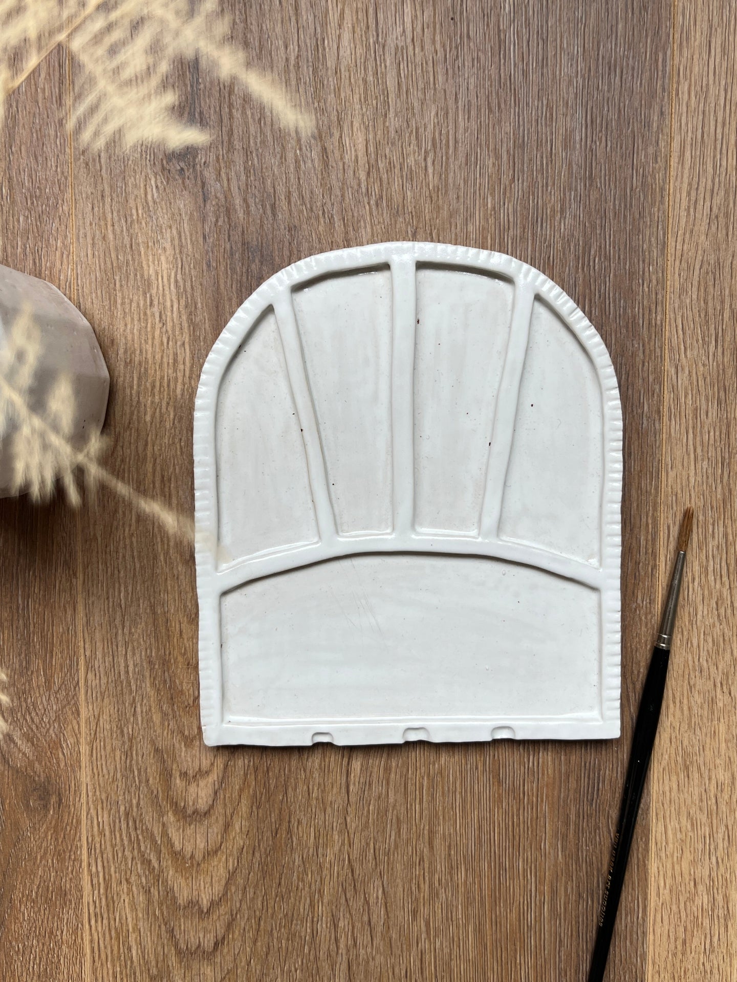 White ceramic watercolor paint palette with paintbrush